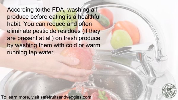 Hands washing produce in the sink with information on why FDA recommends washing produce.